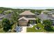 Lovely home with manicured front lawn, contrasted by mature shade trees and lush surrounding foliage at 27094 Carolina Astor, Wesley Chapel, FL 33544