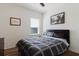 Comfortable bedroom featuring a stylish bed, natural light, and hardwood floors at 27094 Carolina Astor, Wesley Chapel, FL 33544
