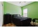 Comfortable bedroom with verdant walls, dark furniture, and natural light from the window at 27094 Carolina Astor, Wesley Chapel, FL 33544