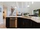 Stylish kitchen featuring a large island with stainless steel appliances and an open view of the living room at 27094 Carolina Astor, Wesley Chapel, FL 33544
