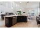 Open concept kitchen featuring a large island with seating that opens to a living room at 27094 Carolina Astor, Wesley Chapel, FL 33544
