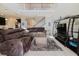 The spacious living room has high ceilings and a large sectional sofa centered on a stylish coffee table at 27094 Carolina Astor, Wesley Chapel, FL 33544