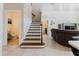 View of the staircase and living room from an open-concept floor plan at 27094 Carolina Astor, Wesley Chapel, FL 33544