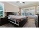 This serene main bedroom offers soft lighting, a large window, and neutral decor at 27094 Carolina Astor, Wesley Chapel, FL 33544