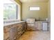 Outdoor kitchen with a built-in grill, stone accents, mini-fridge and countertop space at 27094 Carolina Astor, Wesley Chapel, FL 33544