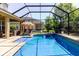 Inviting screened pool with patio furniture, clear blue water, and sunny backyard views at 27094 Carolina Astor, Wesley Chapel, FL 33544
