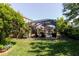 Beautiful backyard pool with a screened enclosure surrounded by lush greenery at 27094 Carolina Astor, Wesley Chapel, FL 33544