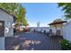 Expansive wooden backyard deck featuring lounge chairs and dining set for comfortable outdoor living at 2802 Old Bayshore Way, Tampa, FL 33611