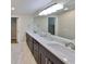 Bright bathroom with double vanity, expansive mirror and stylish modern fixtures at 2802 Old Bayshore Way, Tampa, FL 33611