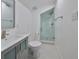 A modern bathroom featuring a glass-enclosed shower, toilet, and a stylish vanity with modern fixtures at 2802 Old Bayshore Way, Tampa, FL 33611