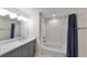 A stylish bathroom featuring a vanity, toilet, and a shower and bathtub combination at 2802 Old Bayshore Way, Tampa, FL 33611