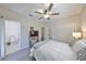 Bright bedroom with a ceiling fan, closet, and a door to the bathroom with toilet and a modern shower at 2802 Old Bayshore Way, Tampa, FL 33611