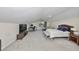 A spacious bedroom featuring a work space, seating area, and a plush king-size bed at 2802 Old Bayshore Way, Tampa, FL 33611