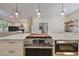 Well-equipped kitchen with stainless steel oven and cooktop in island; open to the living room at 2802 Old Bayshore Way, Tampa, FL 33611
