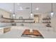 Bright kitchen with an island cooktop and floating shelves, perfect for culinary enthusiasts and gatherings at 2802 Old Bayshore Way, Tampa, FL 33611