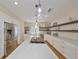 Stylish kitchen featuring sleek countertops, floating shelves, a central island, and modern lighting fixtures at 2802 Old Bayshore Way, Tampa, FL 33611