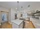 Bright kitchen featuring stainless steel appliances, ample countertop space, and center island with cooktop at 2802 Old Bayshore Way, Tampa, FL 33611