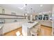 Modern kitchen boasts a center island with seating, floating wood shelves, and open floor plan at 2802 Old Bayshore Way, Tampa, FL 33611
