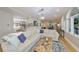 Bright, open living room featuring an L-shaped sofa and an elegant view of the kitchen area at 2802 Old Bayshore Way, Tampa, FL 33611