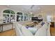 Inviting living room with large arched windows, a fireplace, and ample seating, perfect for relaxation and gatherings at 2802 Old Bayshore Way, Tampa, FL 33611