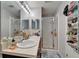 Bathroom includes a double sink vanity, a walk-in shower with glass door, and a large mirror at 2915 Royal Tuscan Ln, Valrico, FL 33594
