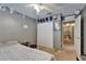 Neutral colored bedroom features a closet, hats as decor, and an open doorway to a hallway at 2915 Royal Tuscan Ln, Valrico, FL 33594