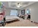 Bedroom with a ceiling fan, neutral walls and carpeted flooring, and access to an ensuite bathroom at 2915 Royal Tuscan Ln, Valrico, FL 33594