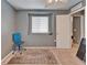 A bedroom featuring neutral colored walls, a window, and a doorway leading to another room at 2915 Royal Tuscan Ln, Valrico, FL 33594