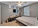 A tidy bedroom features decor, a TV, and a ceiling fan with natural light from the window at 2915 Royal Tuscan Ln, Valrico, FL 33594