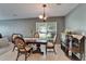Formal dining room showcasing a wooden table with decorative chairs, a window view, and a matching sideboard at 2915 Royal Tuscan Ln, Valrico, FL 33594