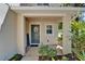 Inviting front porch featuring decorative door, wreath, and lush surrounding landscape at 2915 Royal Tuscan Ln, Valrico, FL 33594