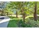 View of a well-maintained green space with mature trees and a walking path at 2915 Royal Tuscan Ln, Valrico, FL 33594