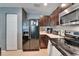 Kitchen with stainless steel microwave and appliances including a black refrigerator, electric stove and dark cabinets at 2915 Royal Tuscan Ln, Valrico, FL 33594