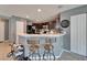 Kitchen bar with modern stools, and dark cabinets, seamlessly integrated into an open-concept living space at 2915 Royal Tuscan Ln, Valrico, FL 33594
