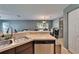 Corner of kitchen featuring stainless steel dishwasher, sink with stainless steel faucet, and view of the dining room at 2915 Royal Tuscan Ln, Valrico, FL 33594
