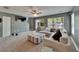 Cozy living room featuring a large sectional sofa, a ceiling fan, and multiple windows with natural light at 2915 Royal Tuscan Ln, Valrico, FL 33594