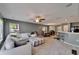 Spacious living room showcasing an open-concept layout with a kitchen bar, dining area, and large sectional sofa at 2915 Royal Tuscan Ln, Valrico, FL 33594
