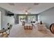 Spacious living room with a large sectional sofa, a ceiling fan, multiple windows, and a view to the backyard at 2915 Royal Tuscan Ln, Valrico, FL 33594
