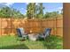 A private backyard with a fire pit and chair setting, surrounded by a wooden fence at 3000 19Th S Ave, St Petersburg, FL 33712