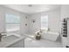 Spacious bathroom with modern fixtures, including a soaking tub, glass-enclosed shower, and double sink vanity at 3000 19Th S Ave, St Petersburg, FL 33712