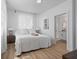 Charming bedroom featuring stylish furnishings, wood floors, and a convenient ensuite bathroom at 3000 19Th S Ave, St Petersburg, FL 33712