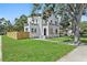 Stunning two-story home boasting a lush green lawn, new wood fence, and mature trees at 3000 19Th S Ave, St Petersburg, FL 33712