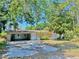 Single-story home with an attached carport and a boarded up window at 312 N Manhattan Ave, Tampa, FL 33609