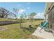 Spacious backyard with a fire pit, patio, lush grass, and a conservation view at 3158 Victoria Inlet Dr, Holiday, FL 34691