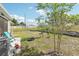 Spacious backyard featuring a fire pit, lush lawn, and a retaining wall perfect for outdoor entertaining at 3158 Victoria Inlet Dr, Holiday, FL 34691