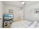 Serene bedroom with a white bed, tv, and minimalist decor, creating a peaceful retreat at 3158 Victoria Inlet Dr, Holiday, FL 34691