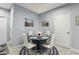 Small dining area with seating for four and two beach themed art pieces at 3158 Victoria Inlet Dr, Holiday, FL 34691