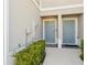 Townhome entryway showing two light blue front doors and manicured landscaping at 3158 Victoria Inlet Dr, Holiday, FL 34691