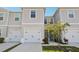 Light and bright townhome exterior with a one car garage and tidy landscaping at 3158 Victoria Inlet Dr, Holiday, FL 34691