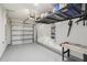 Spacious garage featuring a sealed floor, overhead storage, and an air hockey table at 3158 Victoria Inlet Dr, Holiday, FL 34691